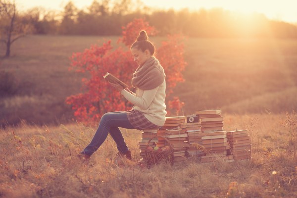 Hipster Girl Reading At Sunset