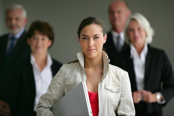 bigstock-An-intern-posing-with-her-supe-28892492